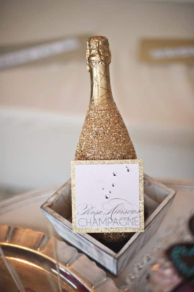 New Years Eve Decor Ideas - Glittered Wine Bottle - DIY New Year's Eve Decorations - Cheap Ideas for Banners, Balloons, Party Tables, Centerpieces and Festive Streamers and Lights - Cool Placecards, Photo Backdrops, Party Hats, Party Horns and Champagne Glasses - Cute Invitations, Games and Free Printables #diy #newyearseve #parties