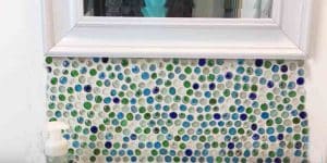 She Does This DIY Bathroom Backsplash With Dollar Store Gems For $6 And It’s Amazing!
