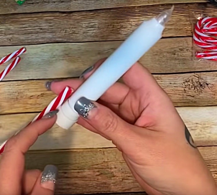 Learn to make a cheap DIY Candy Cane Luminary from Dollar Tree