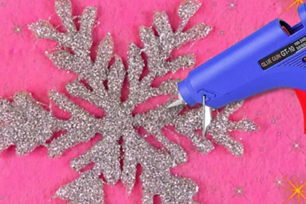 Learn to make a DIY Glue Gun Snowflake With Glitter