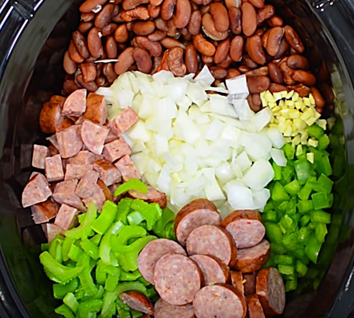 Learn to make a delicious red beans and rice recipe in the slow cooker with sausage