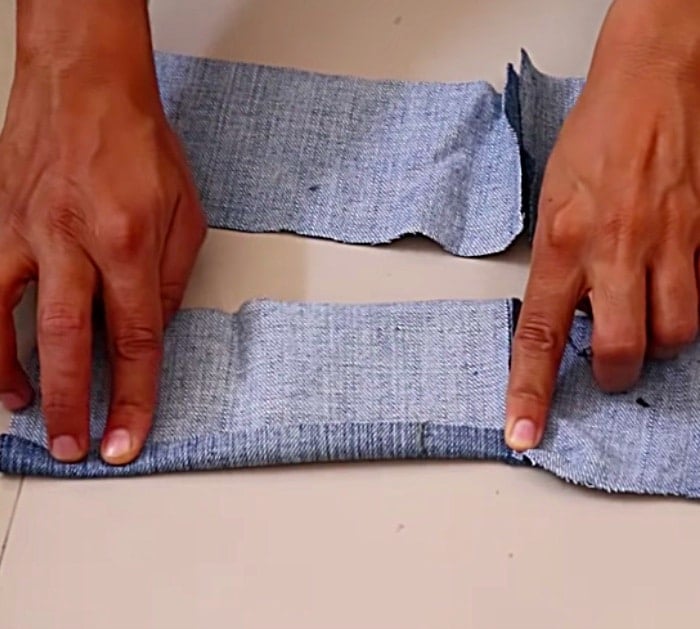 Make a long denim woman's vest out of a large pair of men's jeans