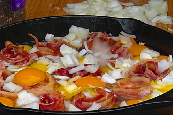 Make Bacon and Eggs Skillet Pie either on the pit or in the oven