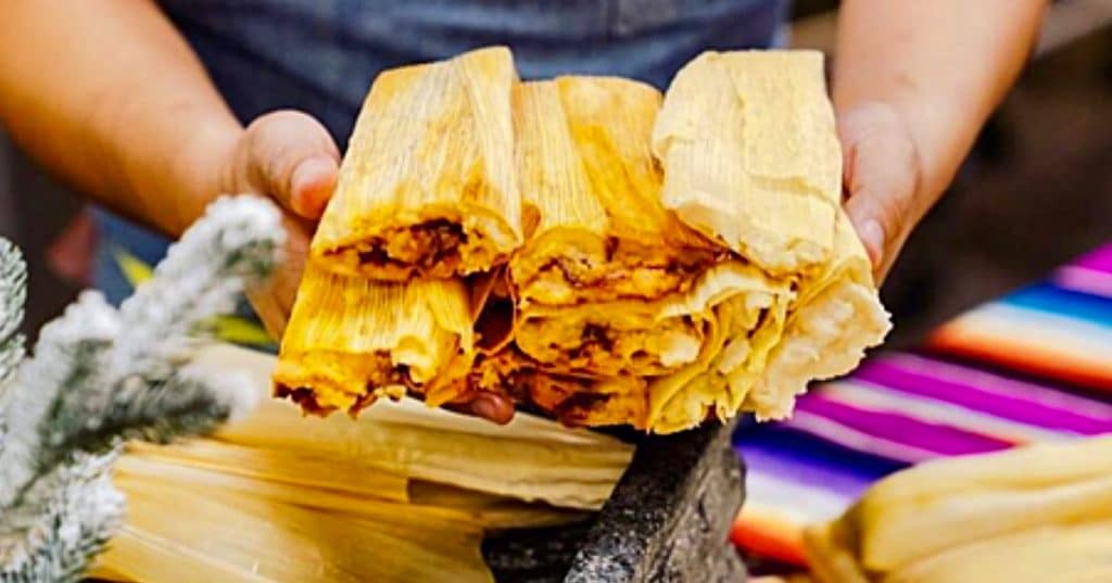 Make homemade tamales with corn husks and pork