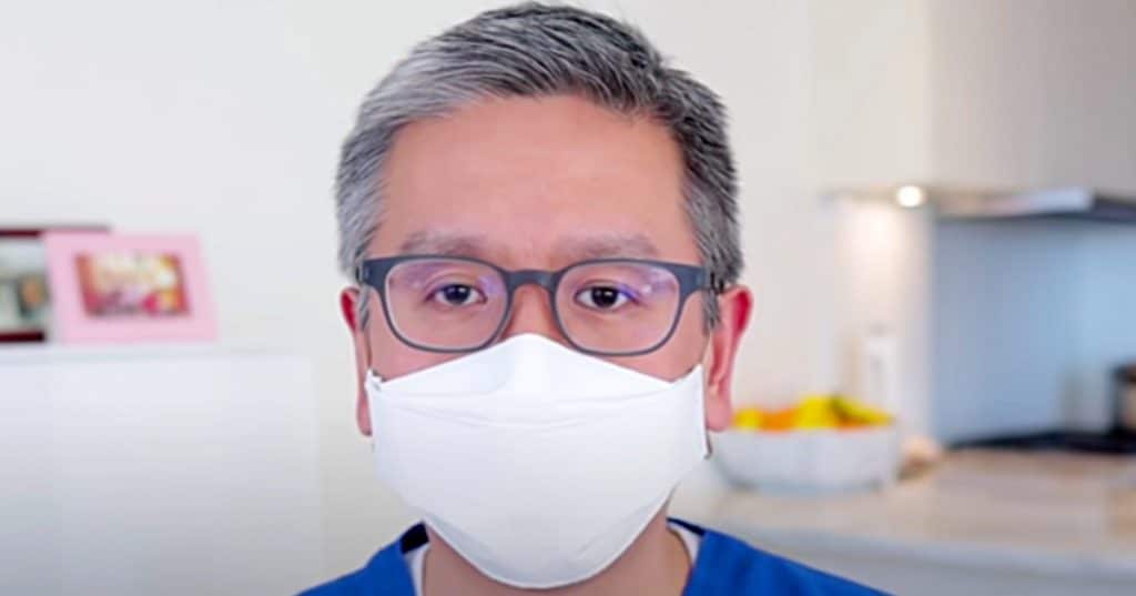 Medical Doctor makes a paper face mask with a stapler and rubber bands