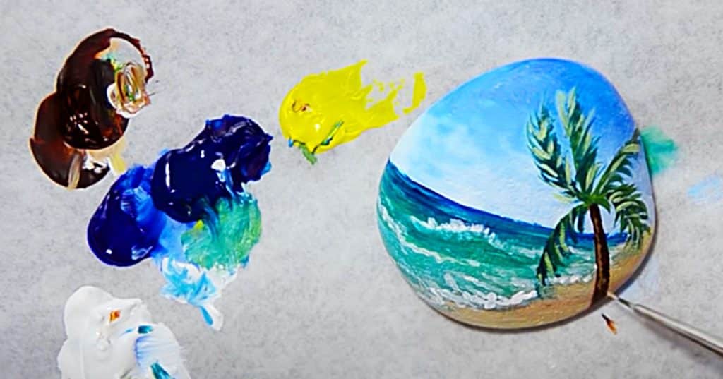 How to paint a beach scene on a rock