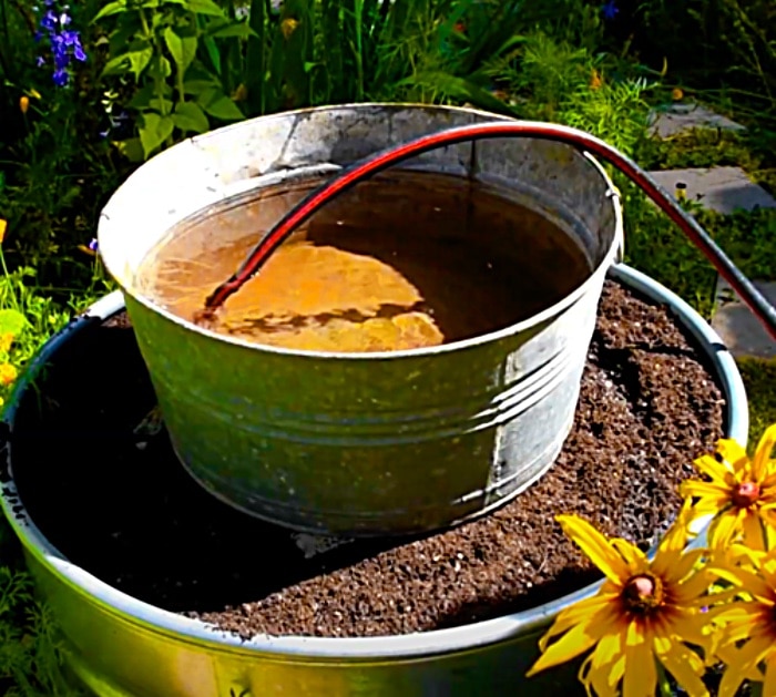 DIY Stock Tank Planter With A Solar Fountain