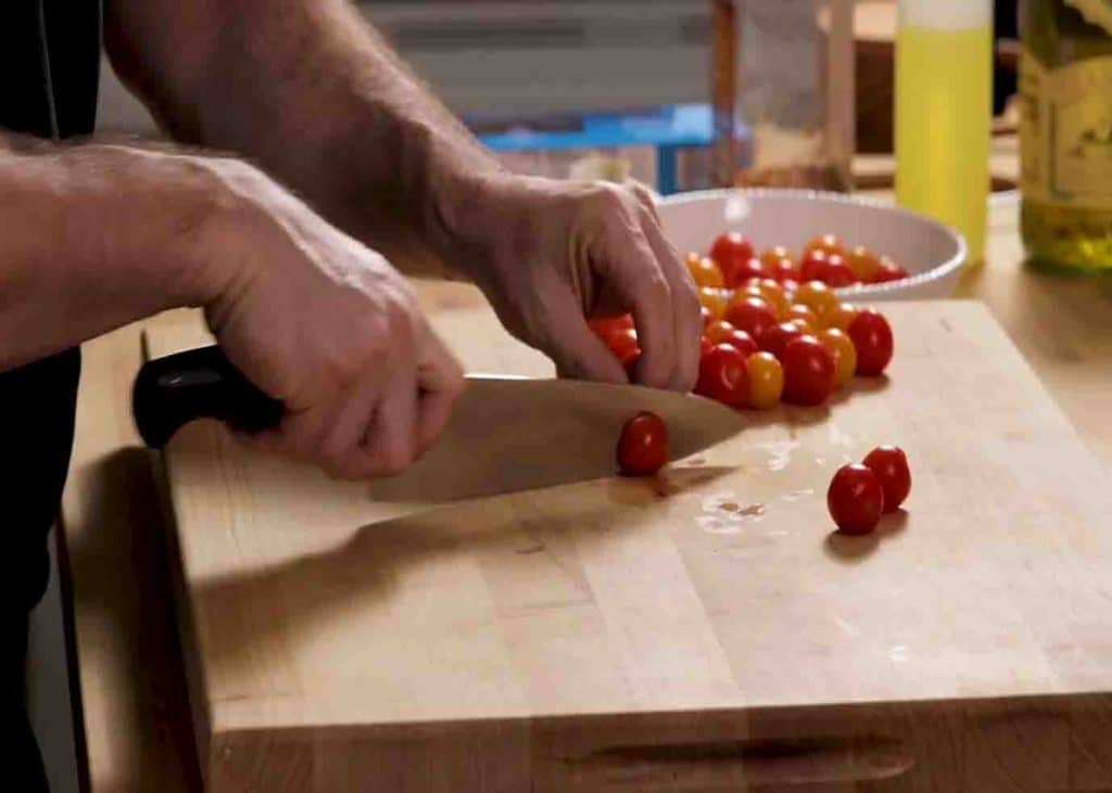 Slicing the cherry tomatoes in half