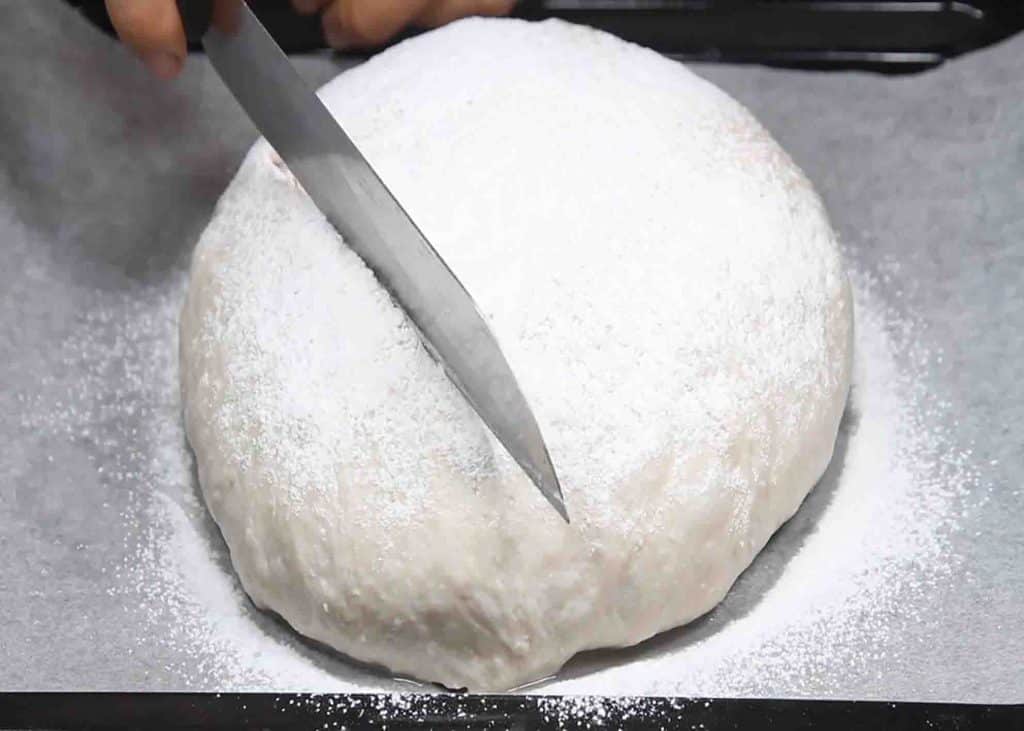 Cutting the top of the Coca-Cola bread slightly
