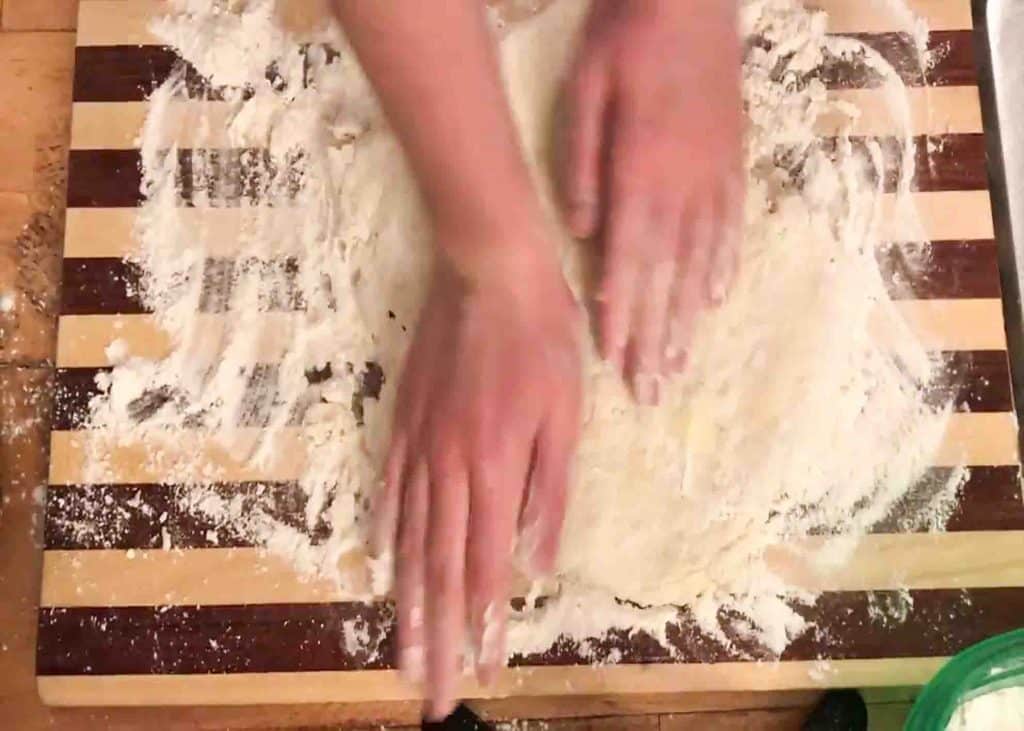 Kneading the dough for cracker barrel biscuits