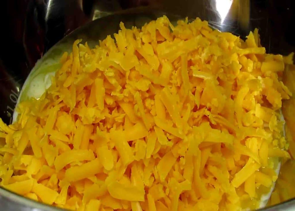 Adding the colby jack shredded cheese into the hash brown mixture