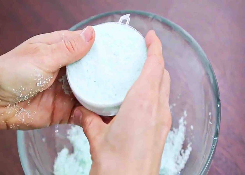 Putting the bath bomb mixture into soap molds