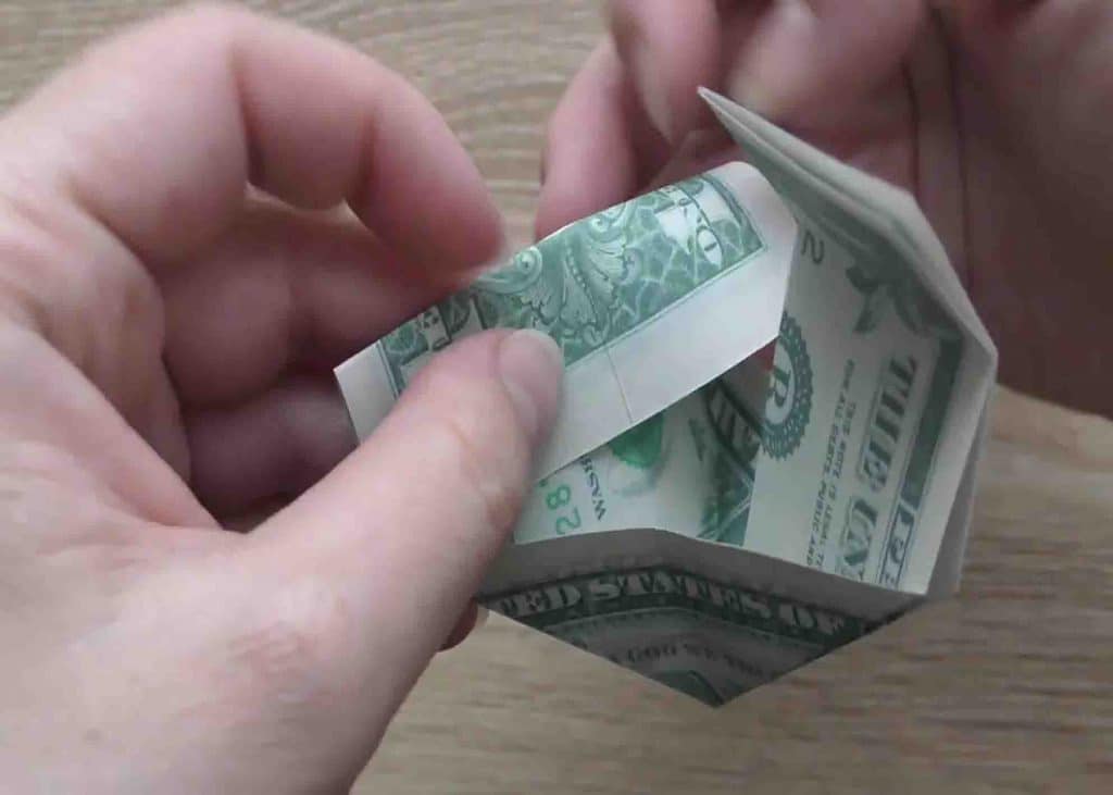 Finalizing the butterfly origami using a dollar bill