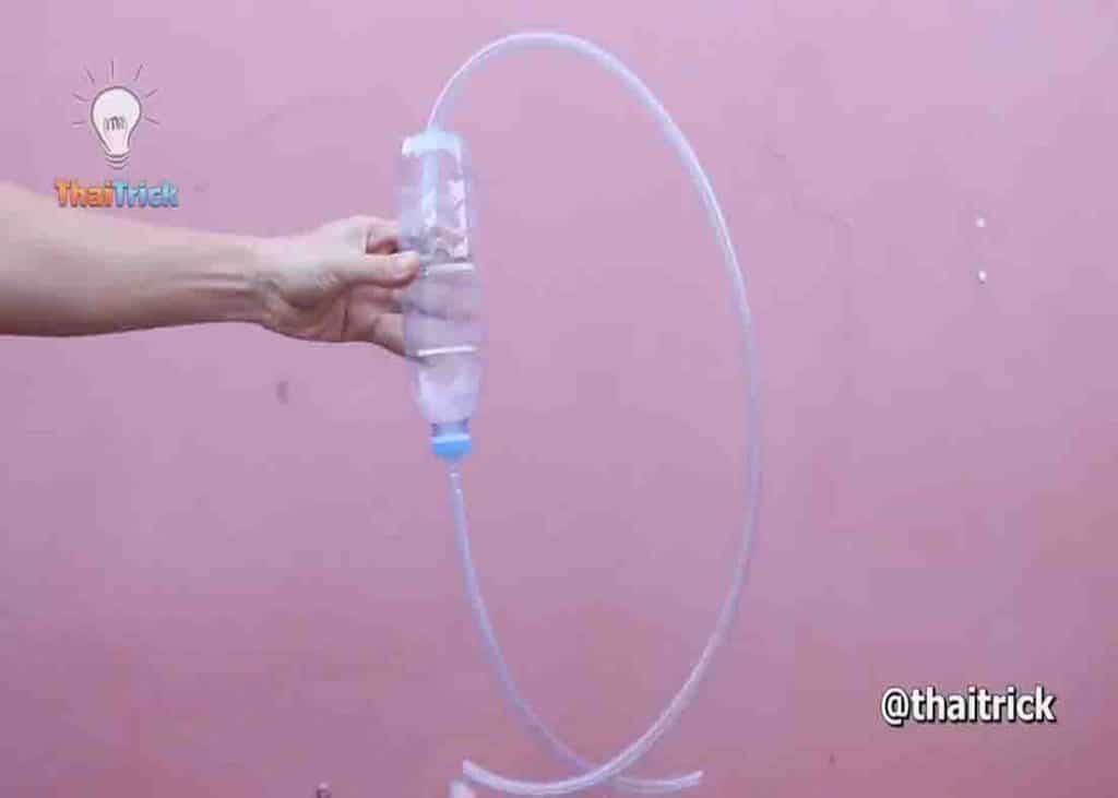 Plastic bottle recycled as a siphon