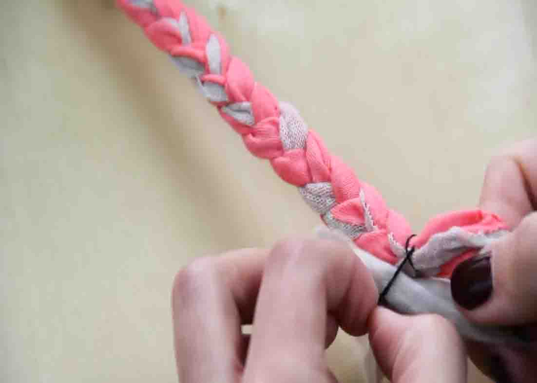 Braiding some fabric strips to make a bracelet