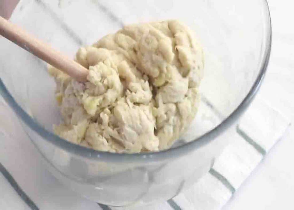 Mixing the flour mixture to form a dough