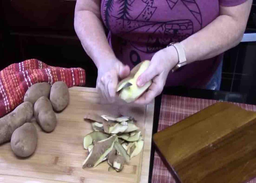 Peeling the russet potatoes