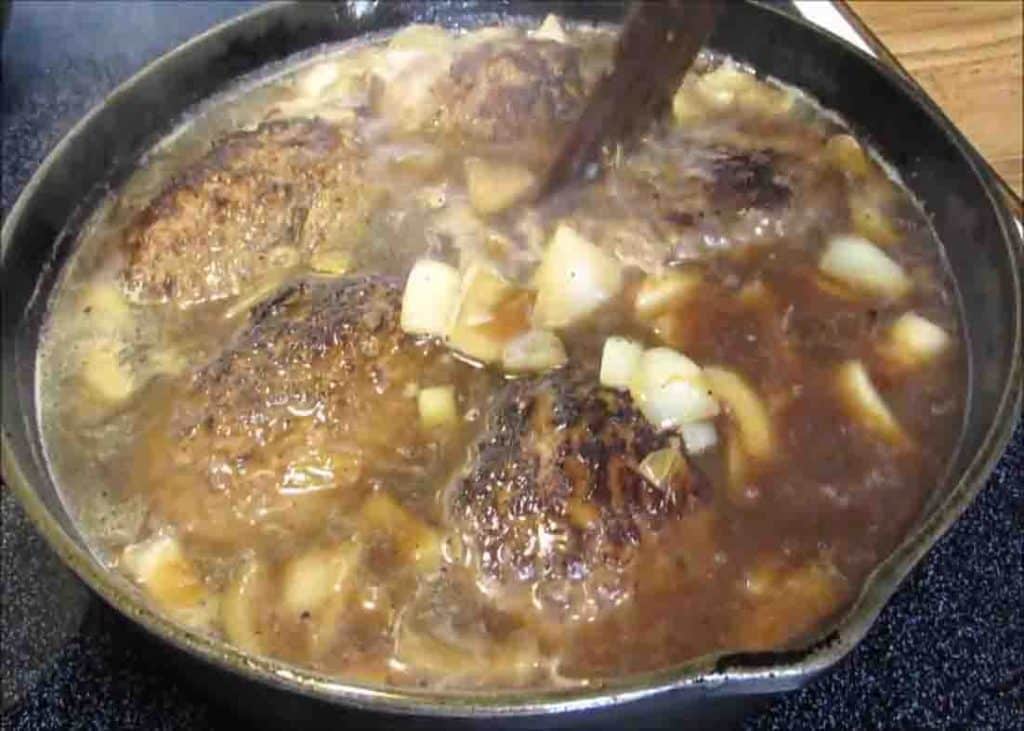 Simmering the salisbury steak and gravy