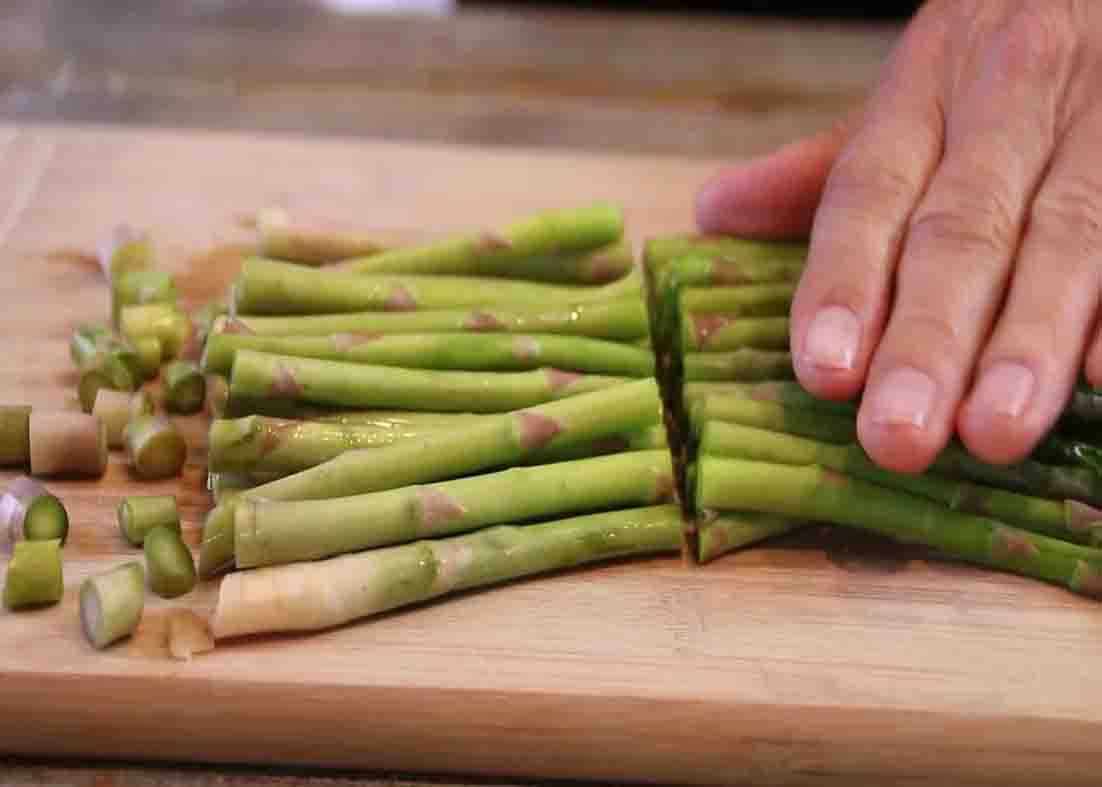 Cutting the asparagus in half