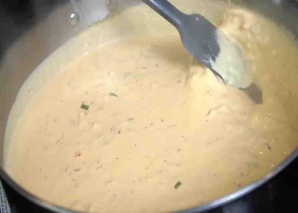 Making the creamy sauce of chipotle chicken pasta