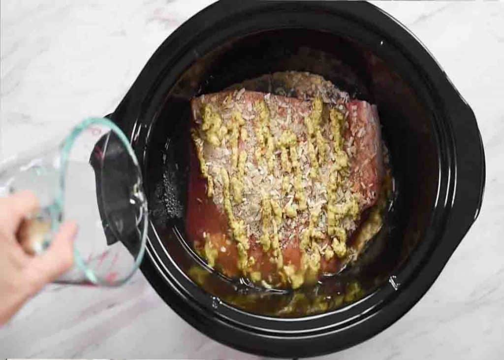 Assembling the bbq brisket to the slow cooker