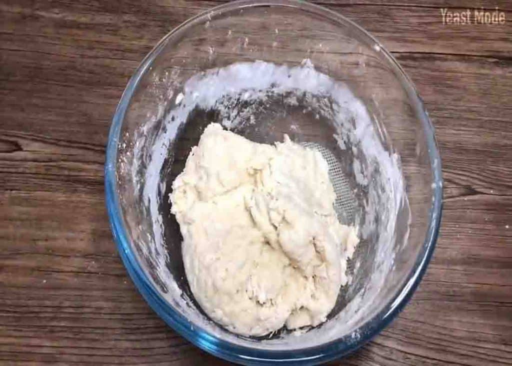 Mixing the flour mixture to form a dough consistency