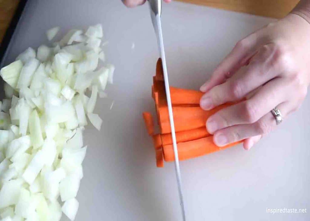 Chopping the veggies to be put on chicken noodle soup