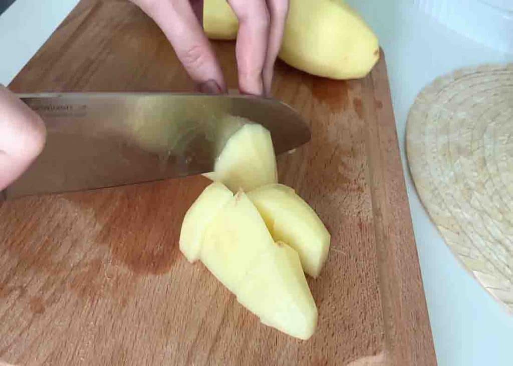 Chopping the potatoes into medium chunks