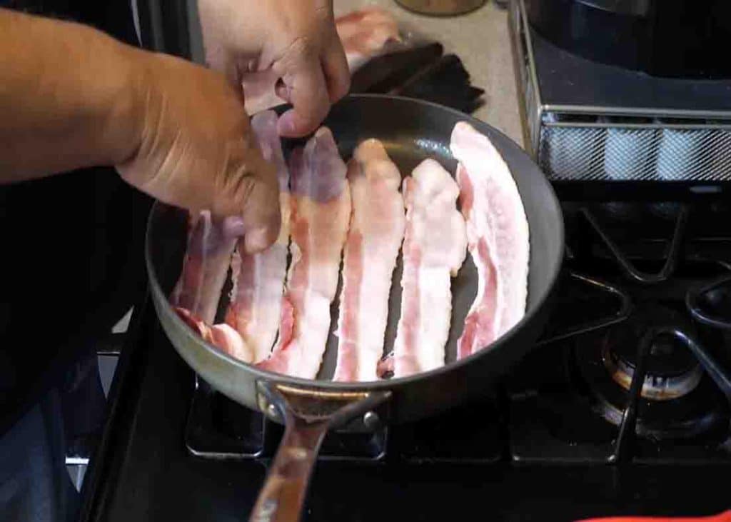 Frying the bacon for the shrimp and grits recipe