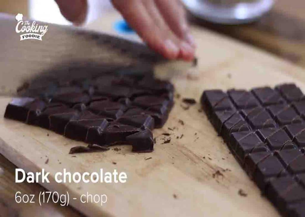 Chopping the dark chocolate for the chocolate oatmeal cake recipe
