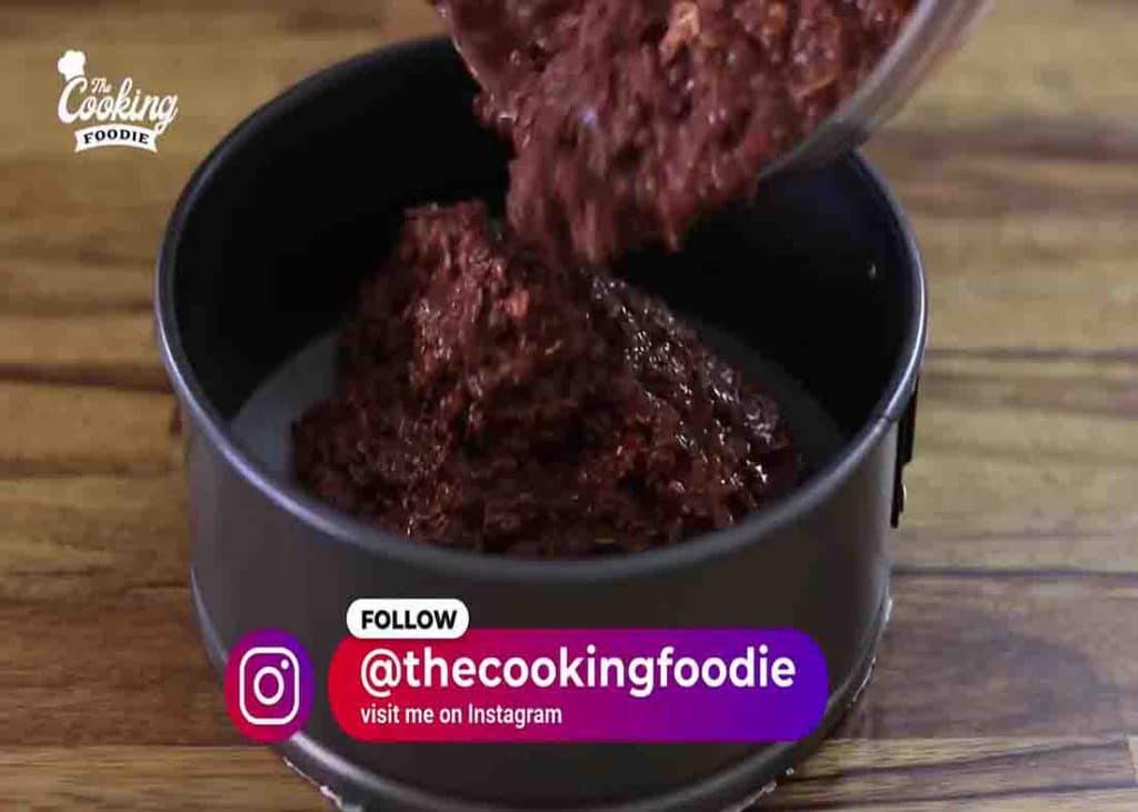 Pouring the oats mixture into the cake pan