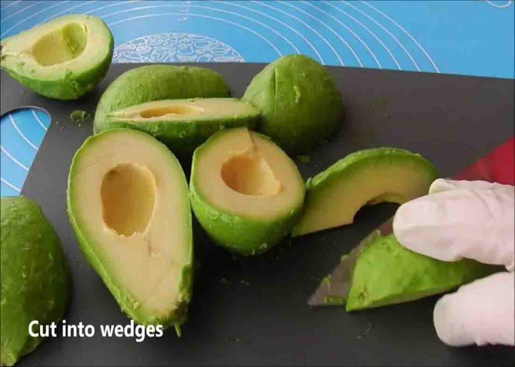 Cutting the avocados in half and removing the seed