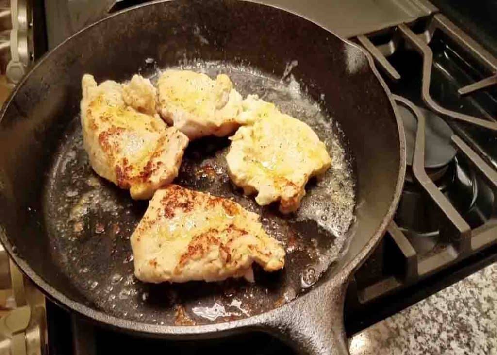 Searing the chicken breasts for the garlic mushroom chicken recipe