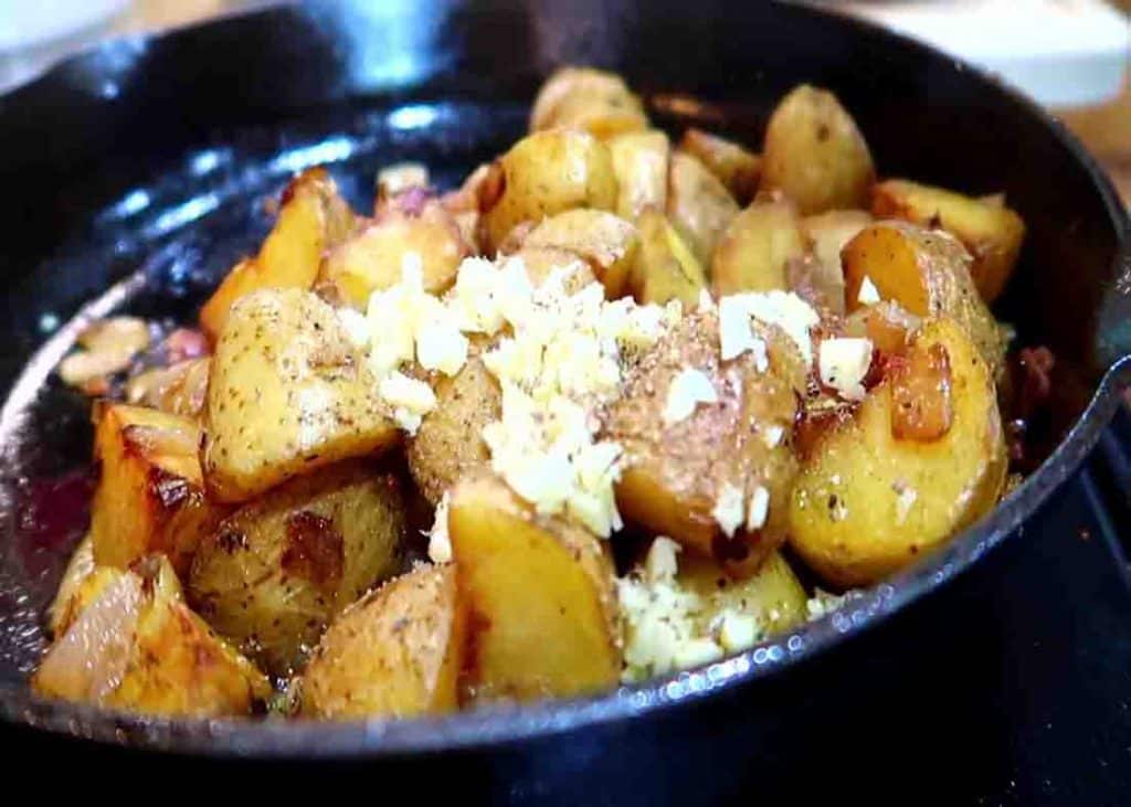 Adding some minced garlic to the pan-fried potatoes