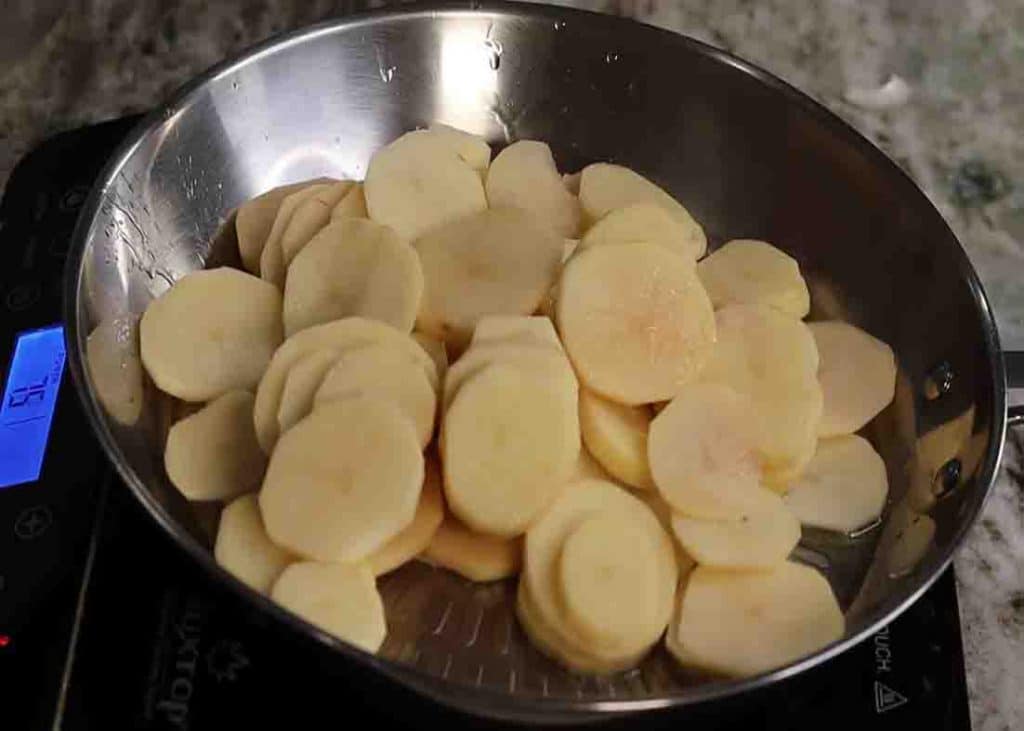 Sauteing the potatoes in the skillet