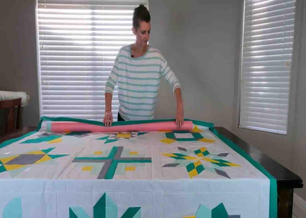 Rolling the quilt top using pool noodles