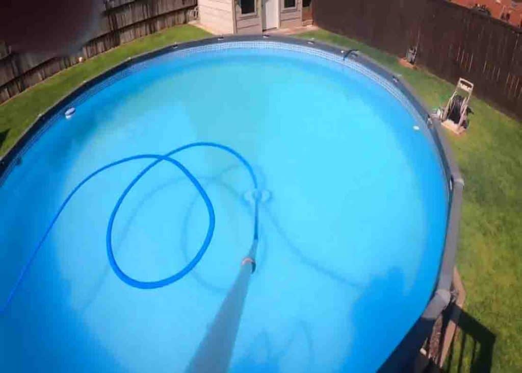Vacuuming the bottom of the pool