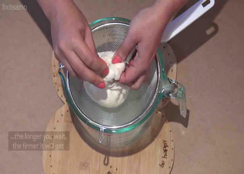 Pressing the cheese to remove excess whey
