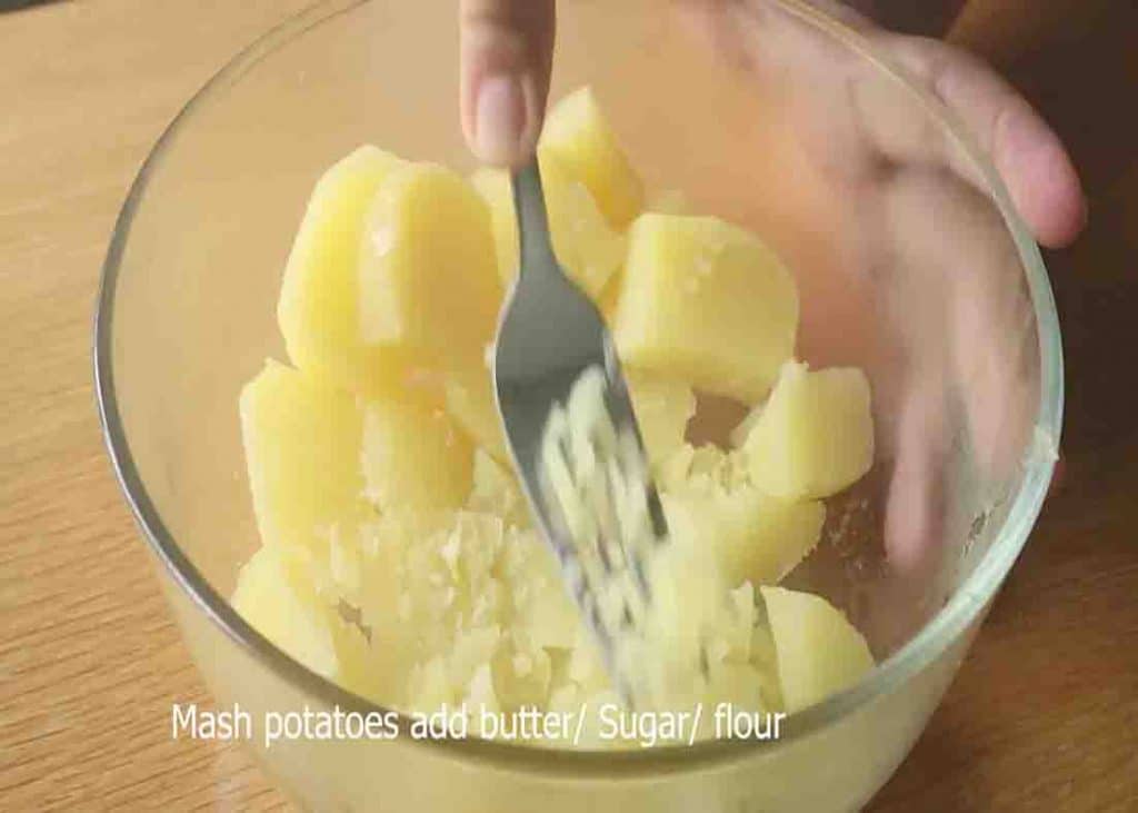 Mashing the potato for the mashed potato cakes