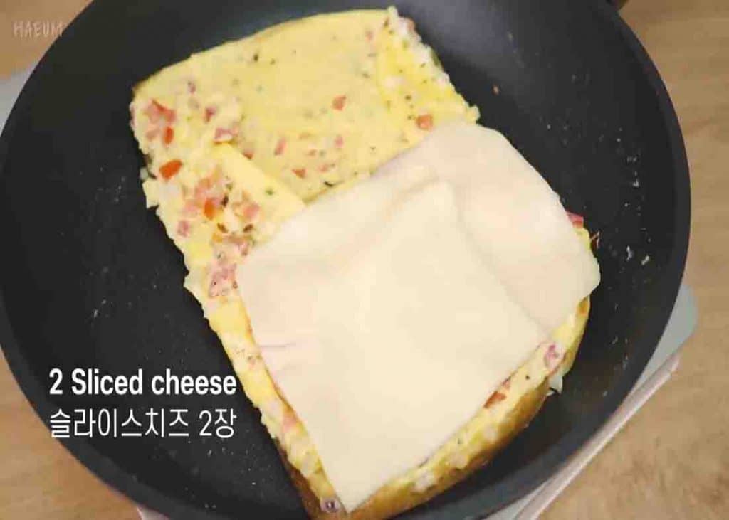Cooking the egg toast in the pan