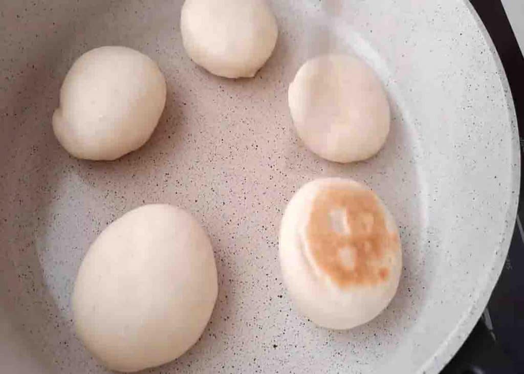 Cooking the bread on the stovetop for 5 minutes on each side