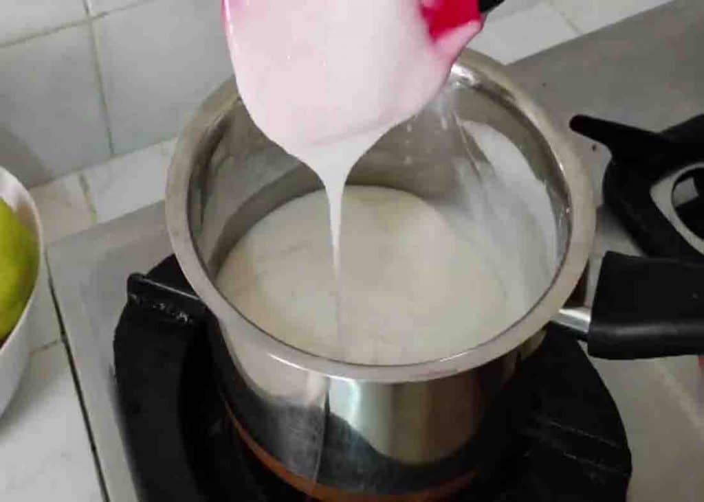 Cooking the coconut pudding mixture over low heat