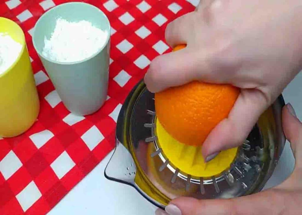 Squeezing the orange for the orange cake recipe