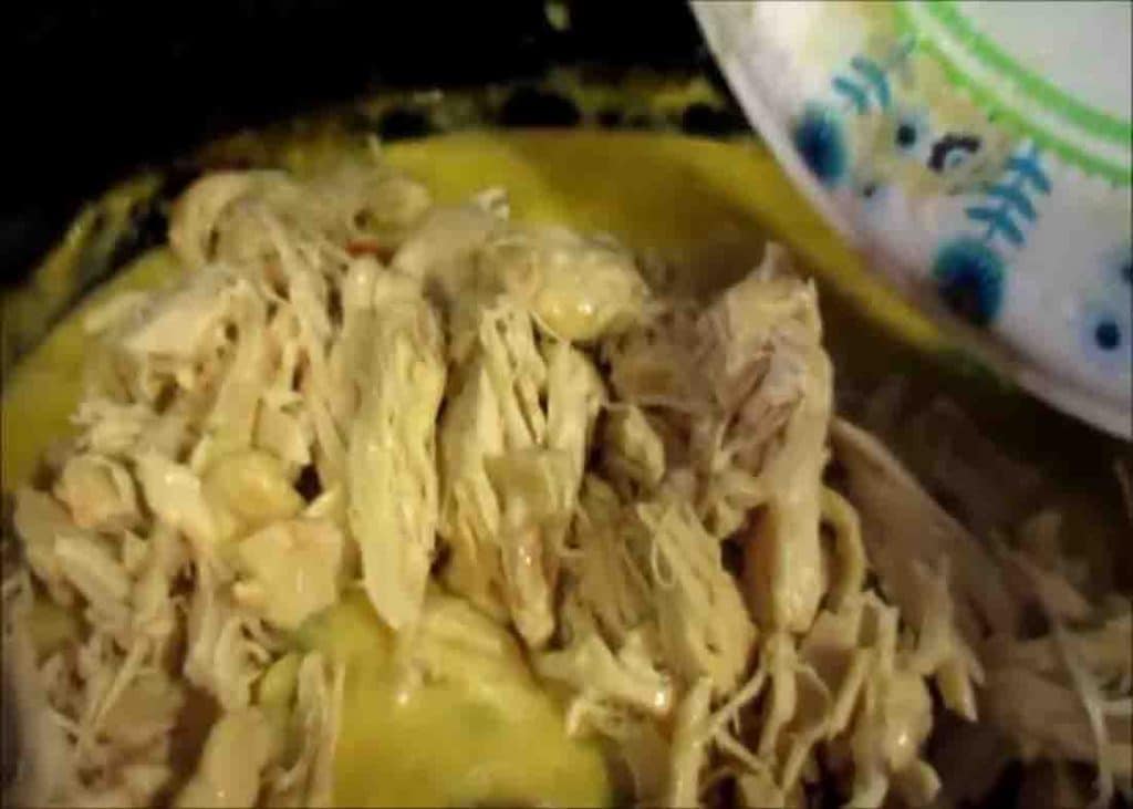 Shredding the chicken of the slow cooker chicken pot pie