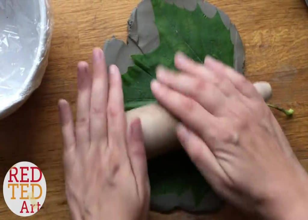 Rolling the leaf into the clay for the autumn leaf bowl