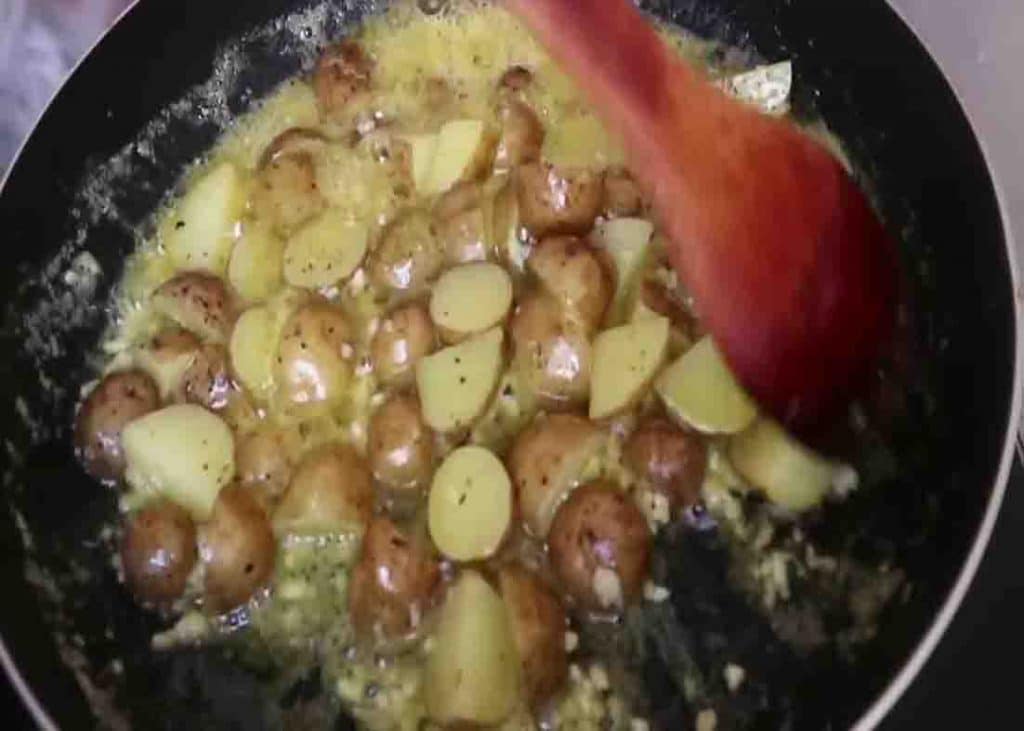 Simmering the butter garlic potatoes for a couple of minutes