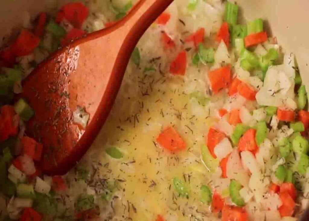 Cooking the base sauce of the chicken and biscuit casserole