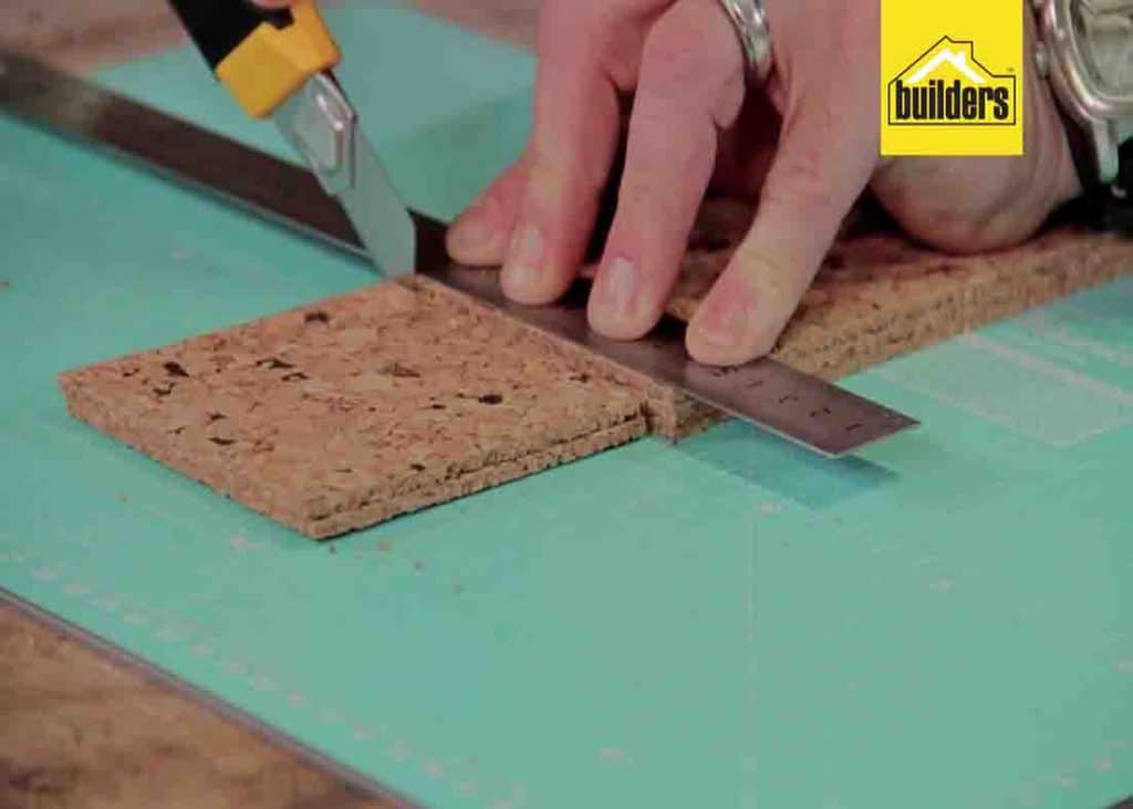 Cutting the cork tiles for the base of the wine cork coasters