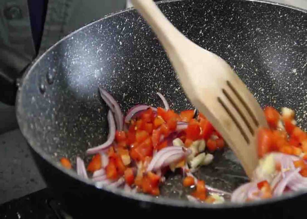 Sauteing the onion and bell peppers for the drunken beef noodles