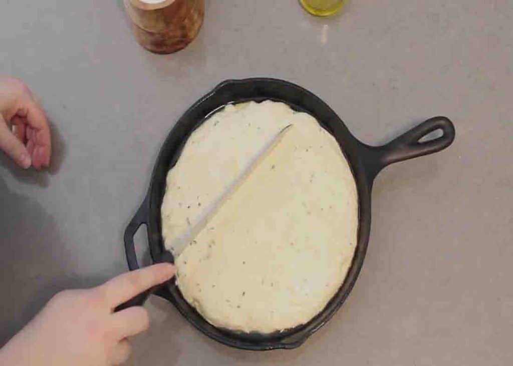 Cutting the top of the skillet bread dough slightly